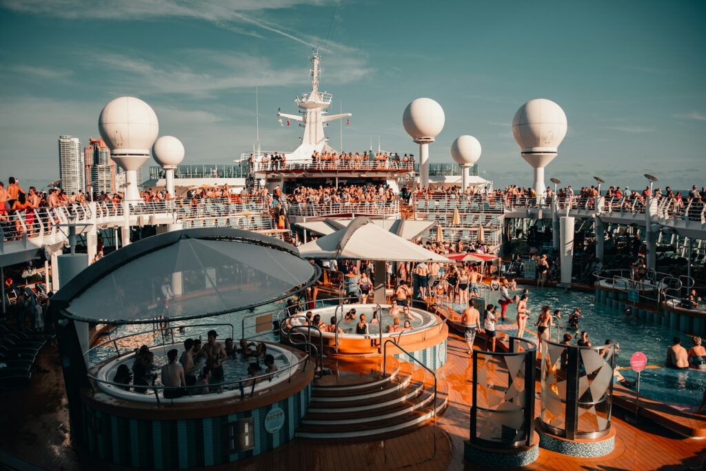 Families on a cruise ship deck overlooking the Caribbean sea